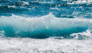 Blue ocean waves with sea foam