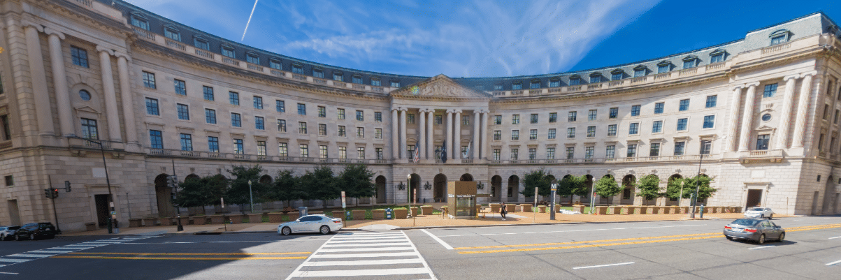 Photo of the Department of the Interior headquarters building with the text overlay "commentary"