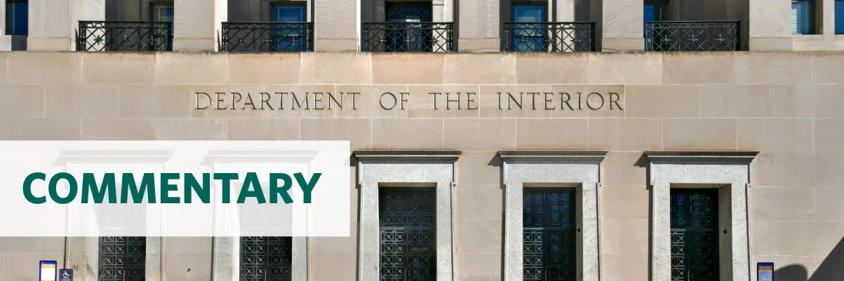 Photo of the Department of the Interior headquarters building with the text overlay "commentary"