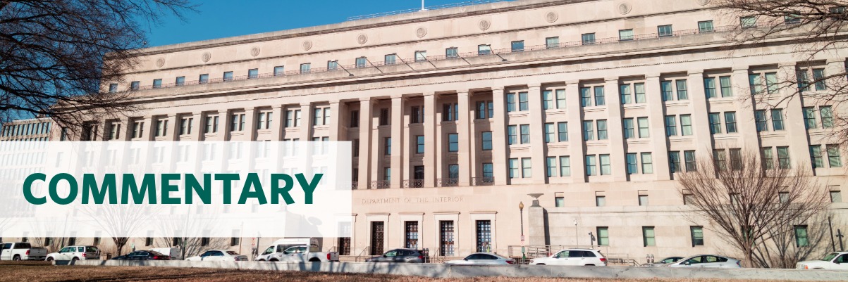 Photo of the Department of the Interior headquarters building with the text overlay "commentary"